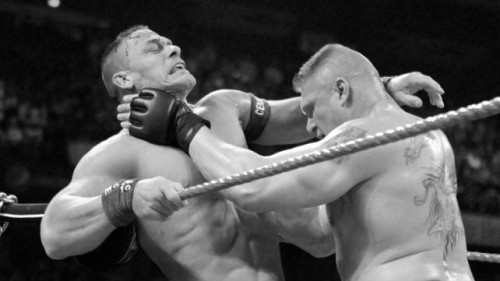 Brock holds Cena's neck